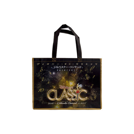 A black and gold laminated non-woven trade show bag with handles and a logo.
