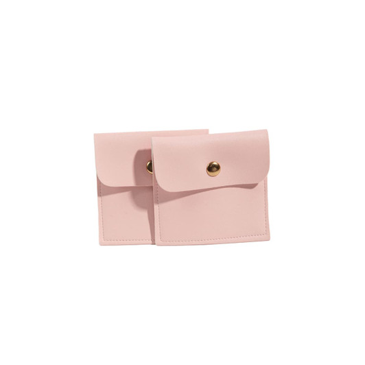 A pair of square, pink PU leather jewelry pouches with a snap closure and decorative gold button.