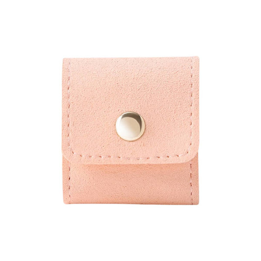 A pink mini synthetic leather jewellery bag with a snap closure and stitching detail. It features a small logo.