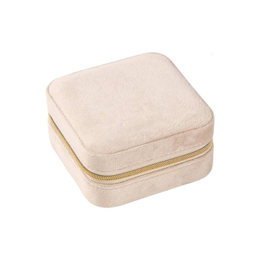 A square velvet jewellery organiser in a soft beige colour with a gold zipper.