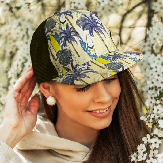 A custom flat peak mesh cap in beige and green, featuring a tropical design with surfboards and palm trees.