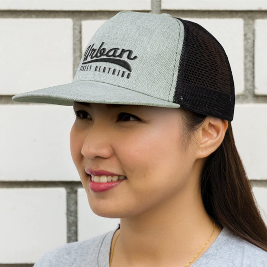 A trucker cap featuring a gray front and black mesh sides with the word "Urban" prominently displayed on the front.