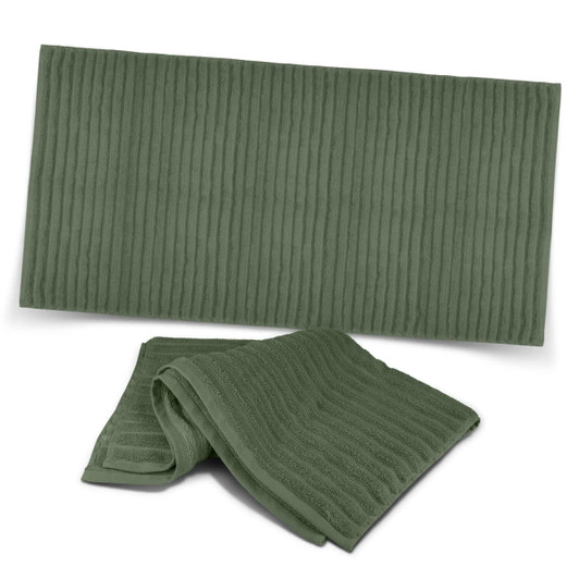Two luxurious green bath towels with a ribbed texture, featuring a logo on one.