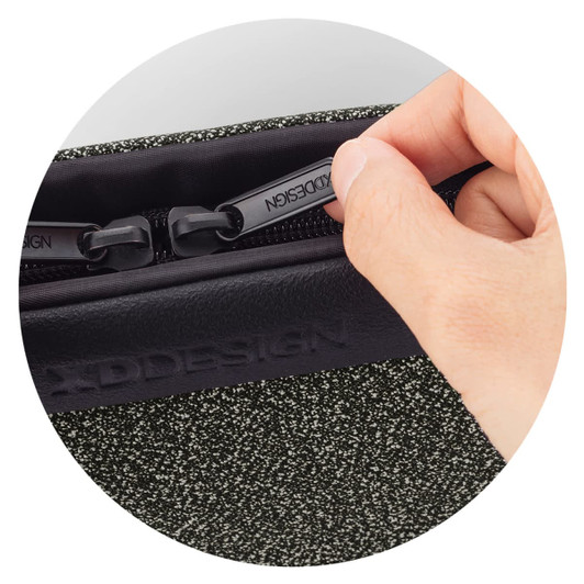 A hand grips the zipper of a textured green Urban Belt Bag, featuring a logo on the side.