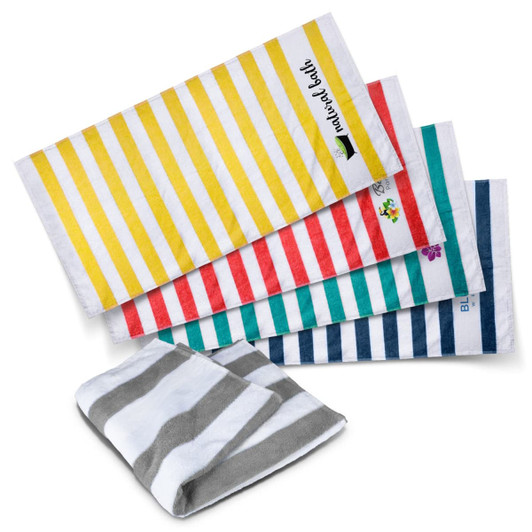 A collection of beach towels featuring multicoloured stripes in yellow, red, green, blue, and grey. One towel is folded.