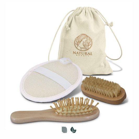 A travel set featuring a natural fibre brush, a wooden brush, a body scrubber, and a cotton drawstring bag.