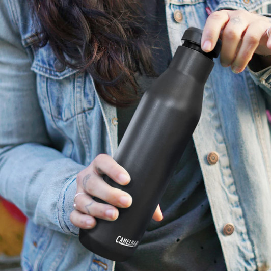 A drink bottle in matte black, holding a CamelBak Horizon Vacuum Bottle, featuring a logo on the side.