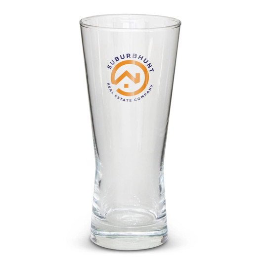 A tall, clear beer glass with a branding logo. The glass features a tapered design.