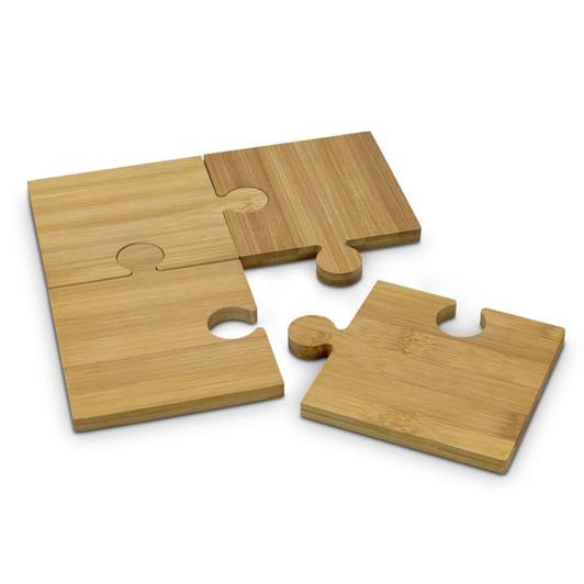 A set of four natural bamboo coasters, designed as interlocking puzzle pieces in light and dark bamboo shades.