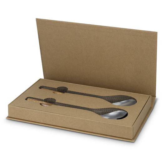 A set of stainless steel salad servers in a brown cardboard box, featuring a textured handle design.