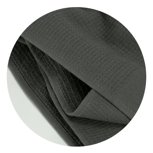 A dark grey waffle towel with a textured surface, featuring a folded design. It has a branding logo.