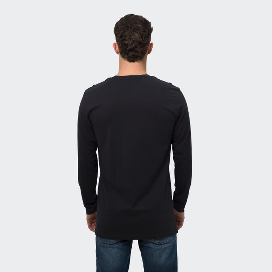 A man wearing a black long sleeve crew shirt, shown from the back, with denim jeans. The shirt features a logo.