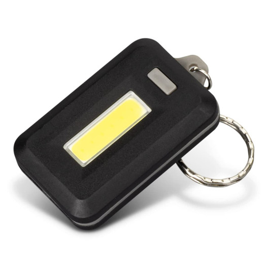 A compact black key ring light with a yellow COB light panel and a metal keychain attachment.