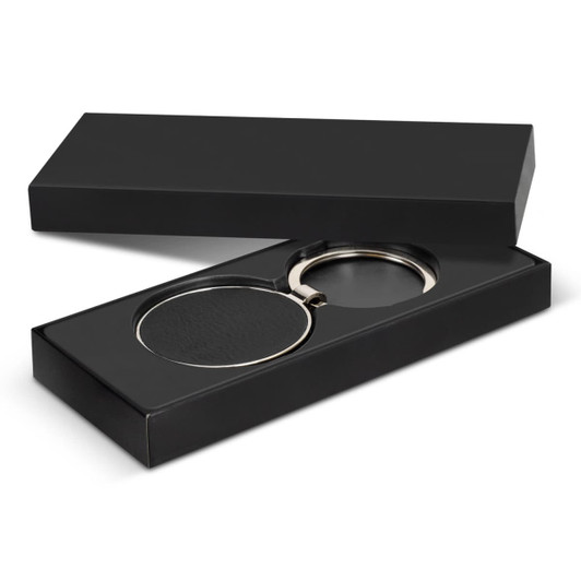 A round black key ring with a silver metal loop presented in a black box.