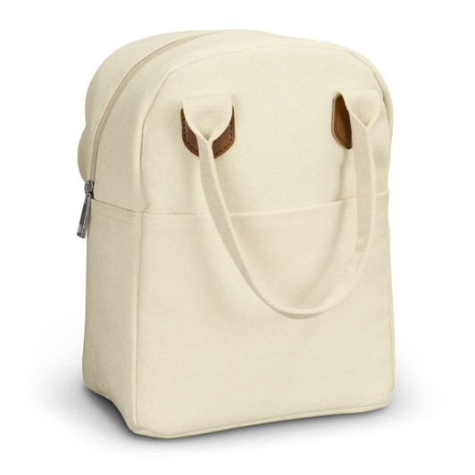 A cream-coloured lunch bag with brown leather handles, featuring a zippered opening and a front pocket.