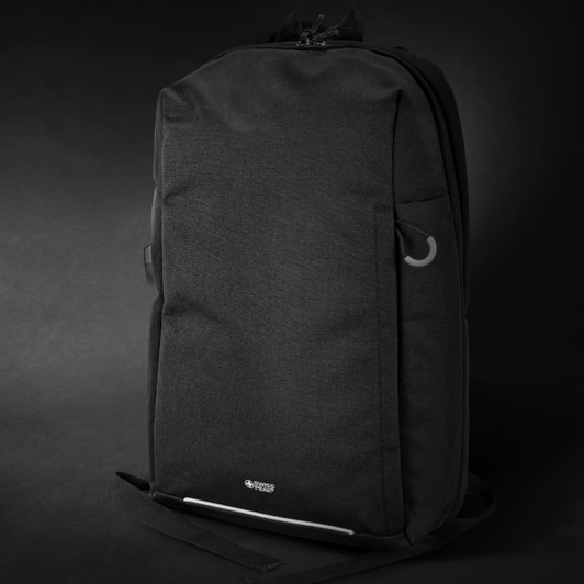 A black backpack with a sleek design, featuring multiple pockets and a logo.