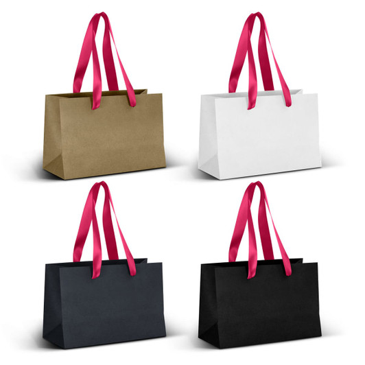 A series of four small ribbon handle paper bags in gold, white, navy, and black with pink handles.