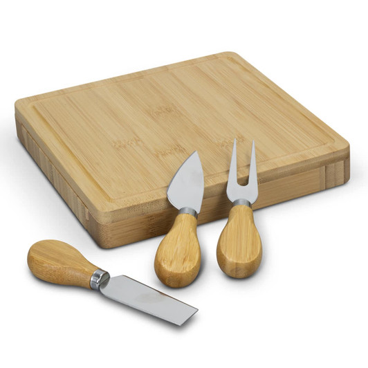 A square bamboo cheese board with three cheese utensils featuring bamboo handles and stainless steel blades.