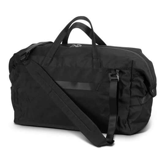 A black duffle bag featuring a shoulder strap and dual handles, with a simplistic design and a logo on it.