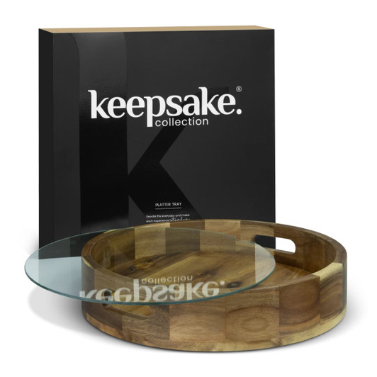 A wooden platter tray with a glass top, presented in a black branded box. The tray features a circular design.