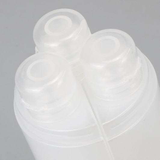 A travel bottle set featuring three clear bottles with white caps, arranged together in a compact design.