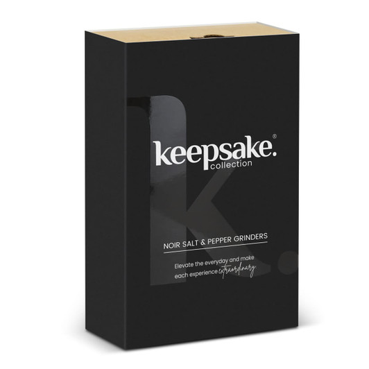 A black box containing Keepsake Noir salt and pepper grinders, featuring a sleek logo and elegant design.