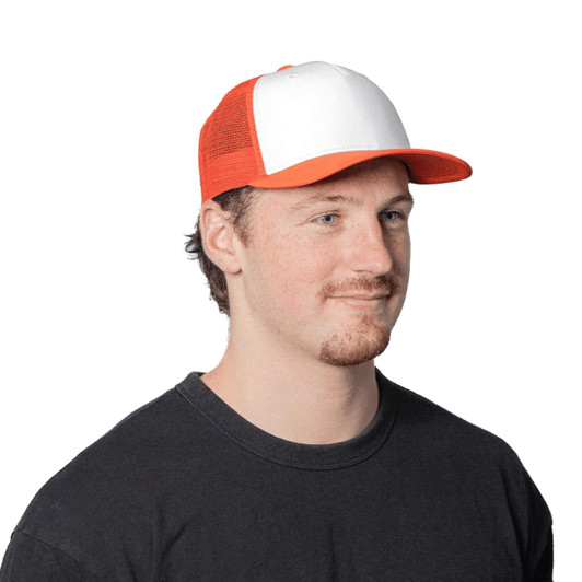 A Turbine Trucker Cap in white and orange, featuring a logo, worn by a man.