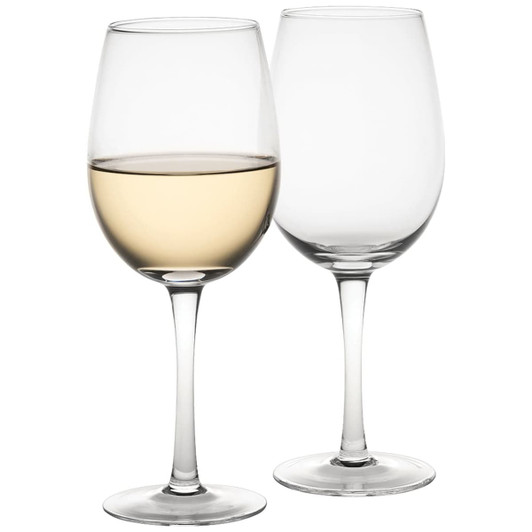 A set of two wine glasses in clear glass, one filled with white wine and the other empty.