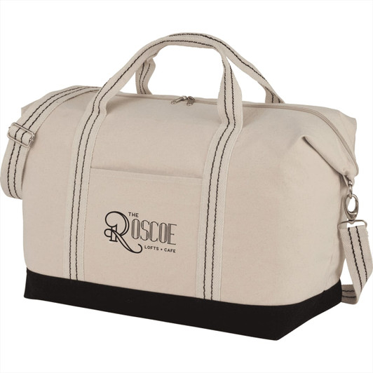A cream cotton canvas duffel bag with a black base, featuring dual handles and a shoulder strap, along with a logo.