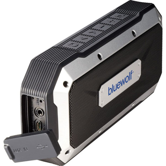 A waterproof outdoor Bluetooth speaker in black and silver, featuring a protective casing and a hidden connection port.