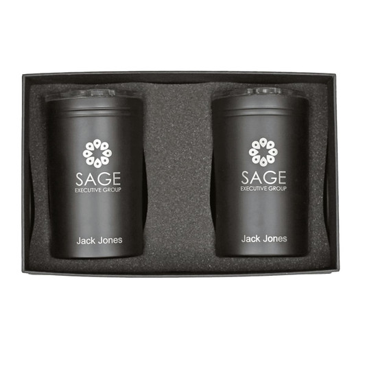A gift box containing two black tumblers with a logo, placed in a protective foam insert.