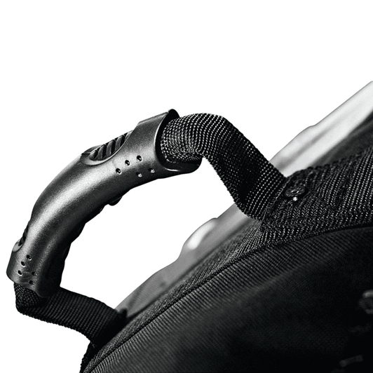 A close-up of a black wheeled duffel bag handle featuring a textured grip and attachment details.