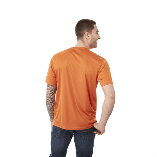 A man wearing an orange short sleeve tech tee, featuring a logo, showing the back view with a tattoo on his arm.