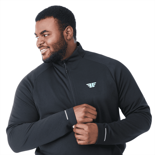 A man wearing a black quarter zip jacket with a logo on the chest, featuring long sleeves and a comfortable fit.