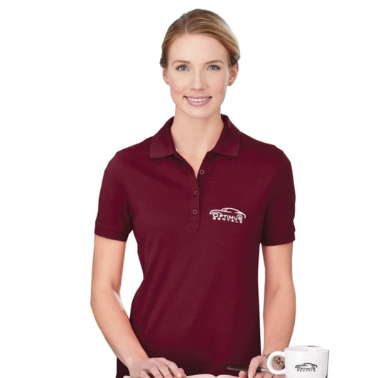 A woman wearing a maroon short sleeve polo shirt with a logo on the left chest.