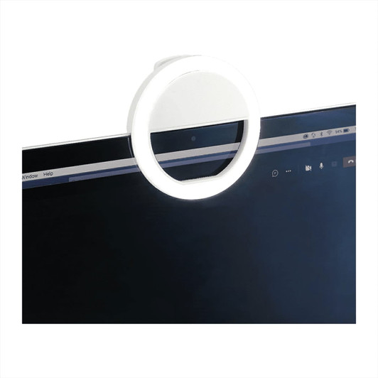 A white circular LED light attached to the top of a laptop screen, illuminating the area around it.
