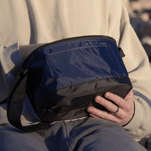 A black and navy insulated cooler lunch bag with a shoulder strap. The bag has a zip closure and a logo.