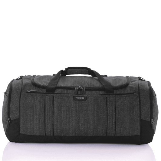 A grey duffle bag with black accents featuring multiple zippered pockets and sturdy handles.