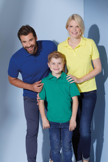 A family poses in three polo shirts: a blue shirt for the man, a green shirt for the boy, and a yellow shirt for the woman.