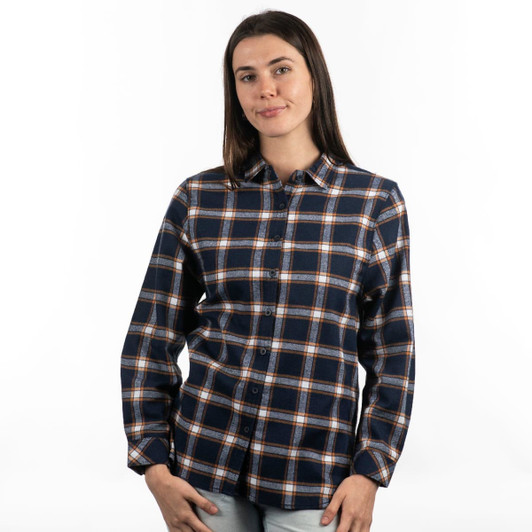 A model poses in a red and black plaid flannel button-up shirt with rolled sleeves. The shirt features a logo.