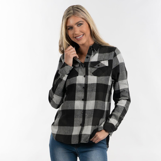 A woman wearing a black and white checkered flannel shirt with button-up front and pockets, smiling at the camera.