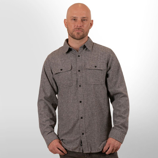 A man wearing a grey long sleeve yarn-dyed flannel button-up shirt with two chest pockets.