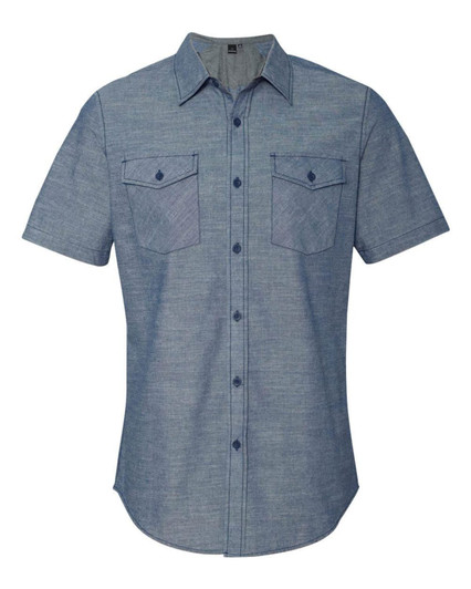 A short sleeve chambray shirt in light blue with two chest pockets and button-up closure, featuring a brand logo.