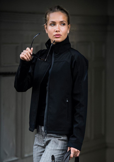 A black soft shell jacket featuring a high collar and stylish design, worn by a model holding sunglasses.