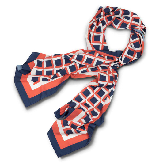 A patterned scarf in hues of coral, navy, and white, featuring geometric shapes and a sleek design.