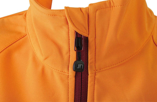 An orange softshell jacket featuring a zippered front and a high collar, with a small logo on the zipper.