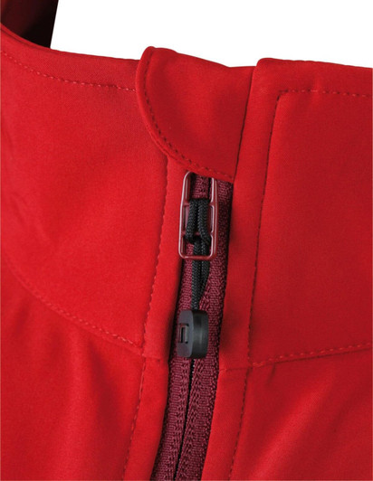 A close-up of a red ladies softshell jacket featuring a zip and collar design. The jacket has a logo on it.