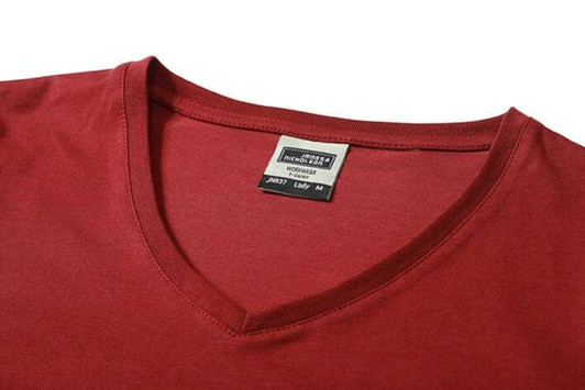 A red ladies' workwear T-shirt featuring a V-neck design and a label inside the neckline.
