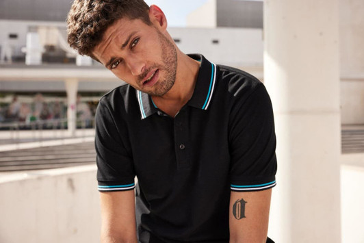 A black polo shirt featuring contrasting light blue trim and a logo on the chest.