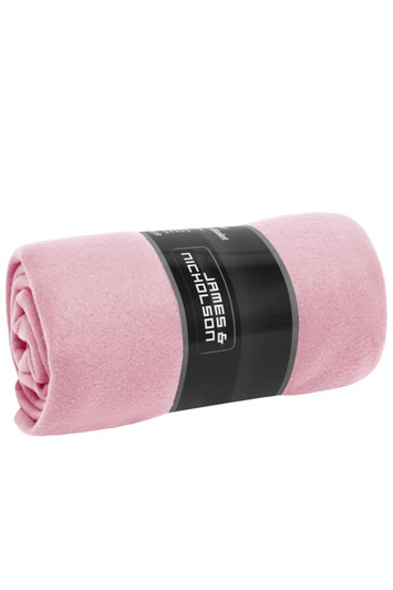 A rolled pink fleece blanket with a black label featuring a logo.